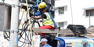Kenya Power staff work on restoring power in the Ganjoni area in Mombasa County.