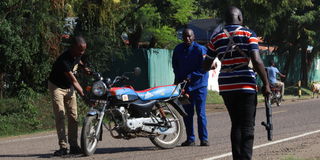 officers seize a motorcycle when a group of riders stormed Homa Bay police station