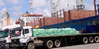 Trucks at the port of Mombasa waiting to be loaded with bags of imported sugar