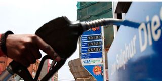 An attendant at a Nyeri petrol station prepares to fill up a car
