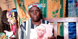 Burnice Kagori Maina holds a photo of her son Saidi Ndung’u who was reportedly killed by Del Monte guards. 