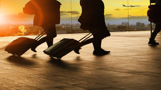 travellers airport suitcases