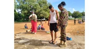Youth being inspected by soldiers during KDF recruitment in Lamu