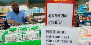 An employee arranges packets of maize flour at Chieni Supermarket