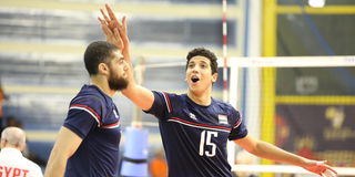 Egypt middle blocker Abdelrahman Seoudy (right) celebrates a point with teammate Mohamed Khater