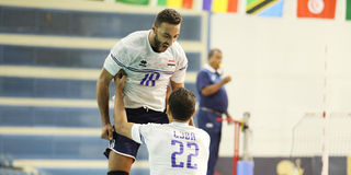 Egypt's outside hitter Ahmed Shafik (top) celebrates with teammate Mohamed Issa 