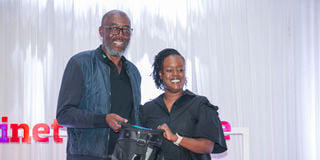 Minet Group chairman Joseph Onsando (left) awards overall winner of the Minet corporate golf tournament Linda Kikuvi 