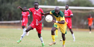 Mathare United forward Timothy Otieno (right) vies for the ball with SS Assad defender Juma Mwajao