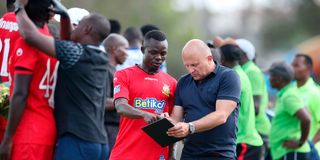 Kenya Police head coach Zdravko Logarusic (right) gives instructions to midfielder David Okoth 