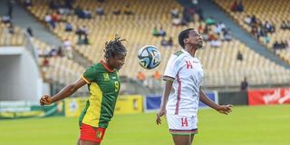 Rising Starlets striker Fasila Adhiambo (right) vies with Cameroon midfielder Marianne Ines Maague