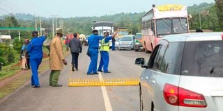 Police officers at a checkpoint in Kisumu.