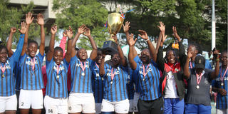 Nairobi Water players and officials celebrate with the trophy