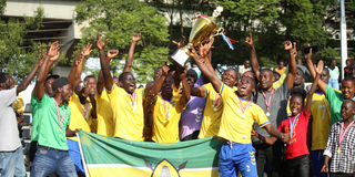 National Cereals and Produce Board players and officials celebrate with the trophy