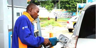 An attendant fuels a motor vehicle