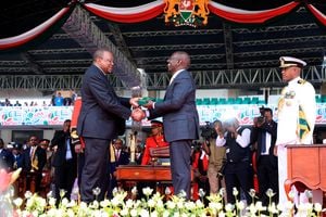 President William Ruto is handed the instruments of power by his predecessor Uhuru Kenyatta.