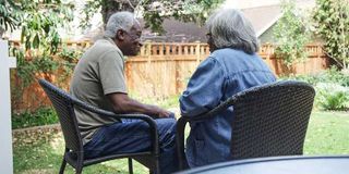 Happy eldery black couple talking in the backyard