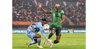 Nigeria's forward Victor Osimhen (right) vies for the ball with Cameroon's goalkeeper Fabrice Ondoa