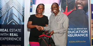 NMG Chairman Dr Wilfred Kiboro hands over prize to Ann Thoronjo