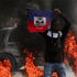 A demonstrator holds up a Haitian flag during a protest against Prime Minister Ariel Henry's