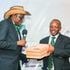 Men winner Tirus Githaiga (right) receives his prize from club chairman Paul Munyao