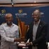 Machakos Golf Club's Charles Kithuku receives the ICEALION King of the course trophy from ICEALION CEO Philip Lopokoiyit 