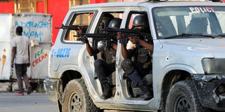 Police officers take part in a confrontation with gangs near the National Palace, in Port-au-Prince, Haiti March 21, 2024.