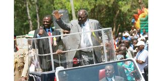 President Mwai Kibaki together with agriculture minister William Ruto waves at the crowd 