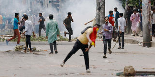 Police carry a wounded police officer bangladesh protests