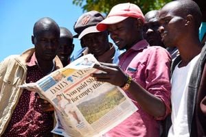 Youth read the Daily Nation newspaper.