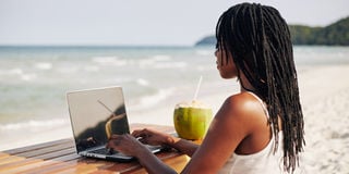 digital nomad woman working on the beach laptop photo