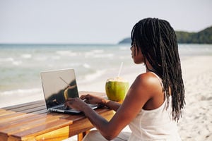 digital nomad woman working on the beach laptop photo